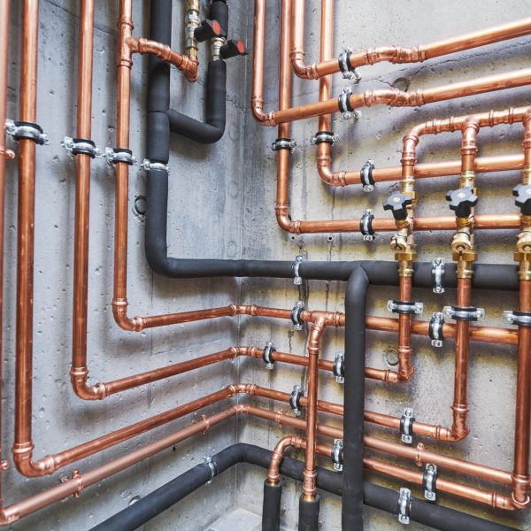 copper pipes of a private house autonomous heating system in boiler room. Plumbing services